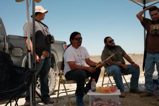 Kenny, Pops, and Cultural Dept staff perform songs.