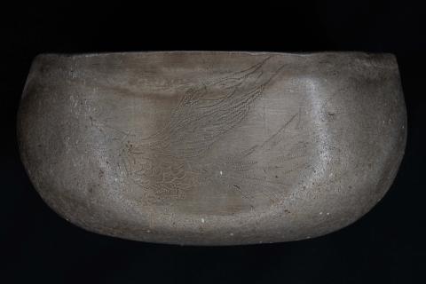 Image of pheonix engraving on cup.